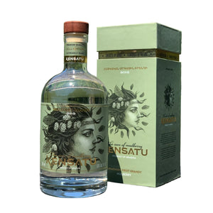 Bottle and box of ENSATU brandy with a scenic background